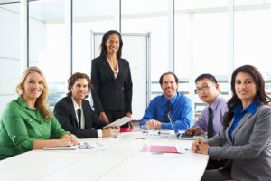 Image of businesspeople around a table in a meeting
