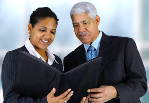 Image of a businesswoman showing a portfolio to a businessman